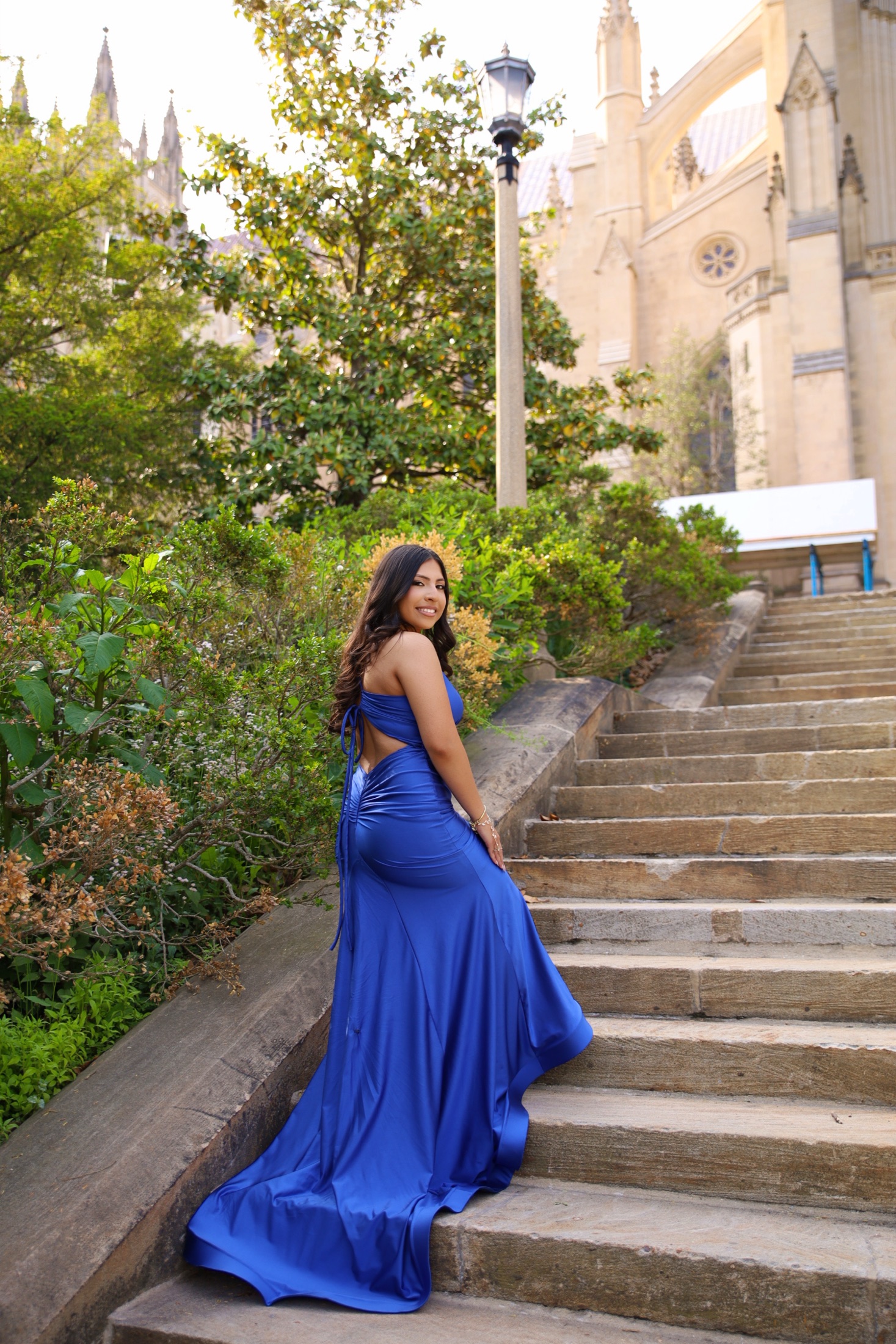 Woman in a royal-blue gown on cathedral steps